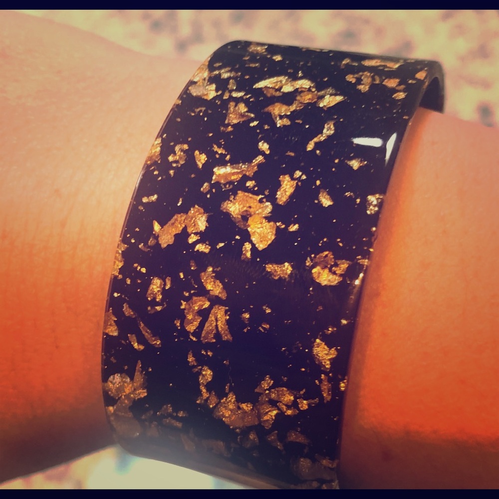 A black and gold acrylic bracelet